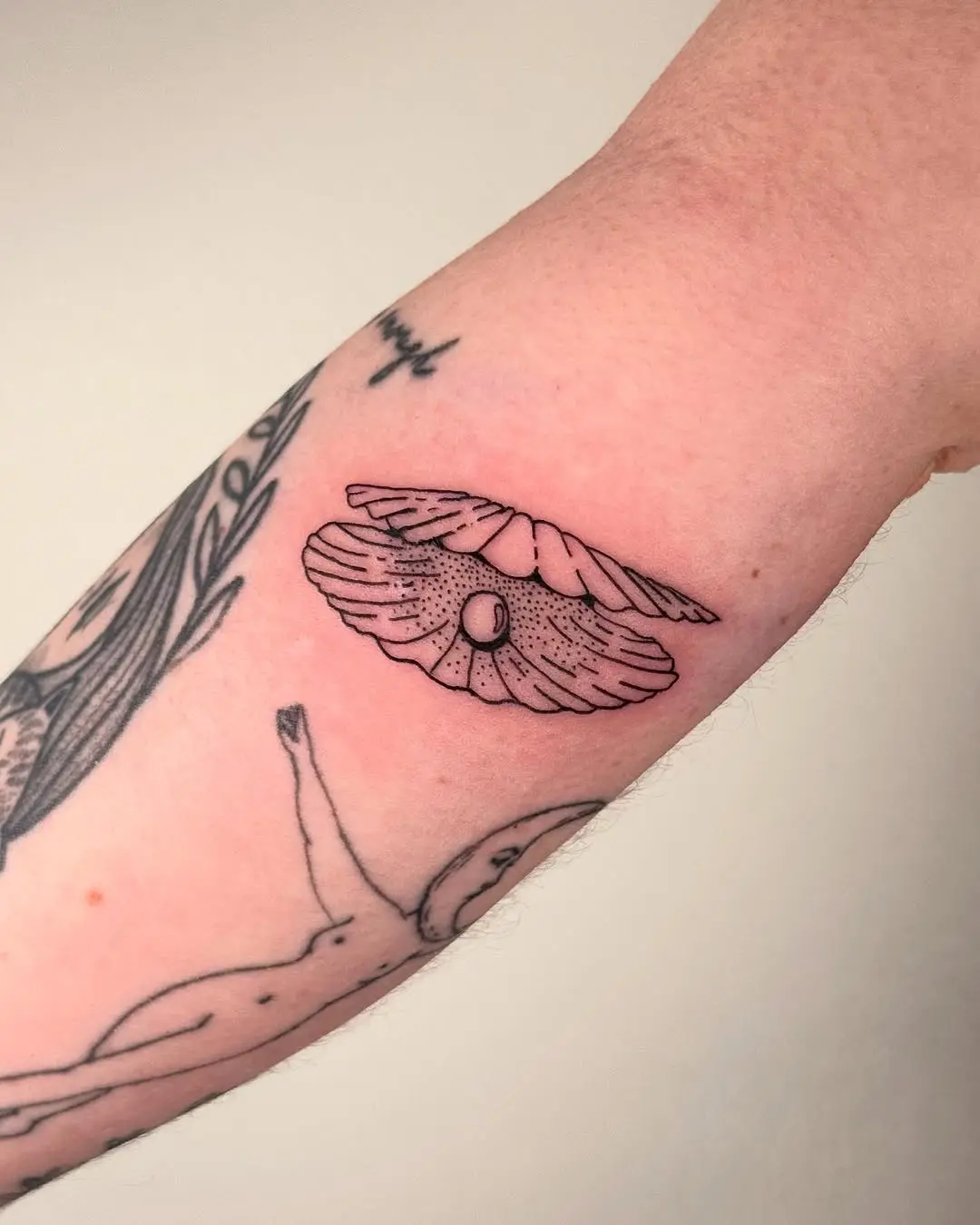Intricate fine line oyster tattoo design