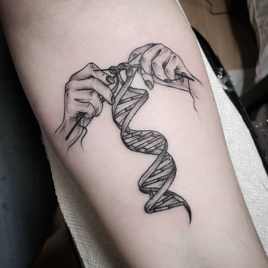 Intricate hands weaving a DNA strand tattoo