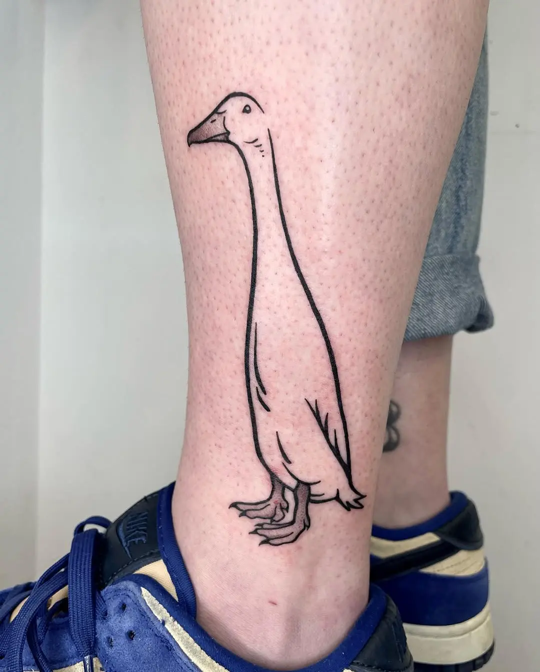 Minimalist duck tattoo with unique character