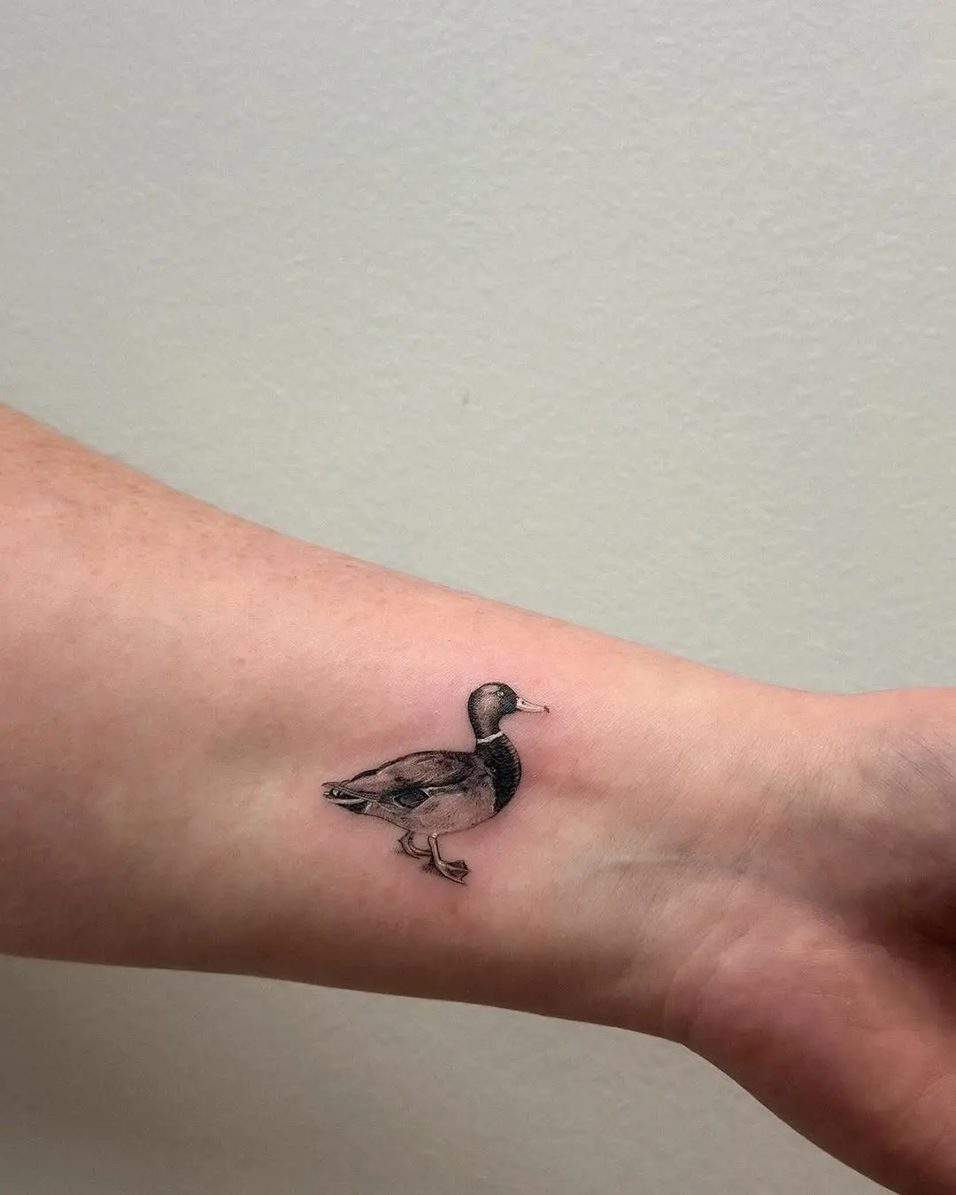 Charming duck tattoo on the forearm
