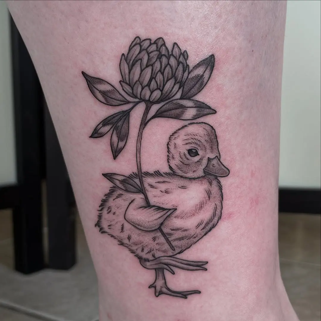 Charming duck tattoo with floral details