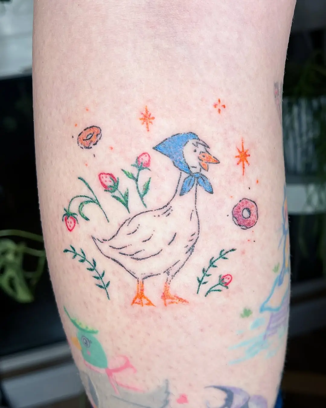 Charming duck tattoo with floral accents