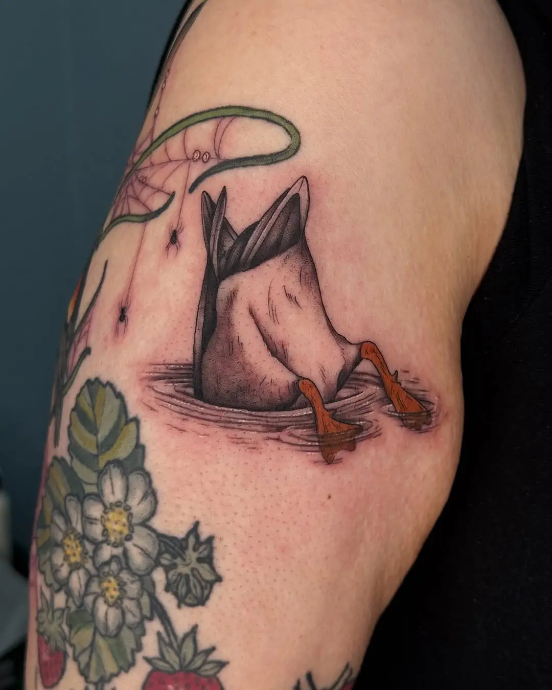 Charming duck tattoo nestled in water