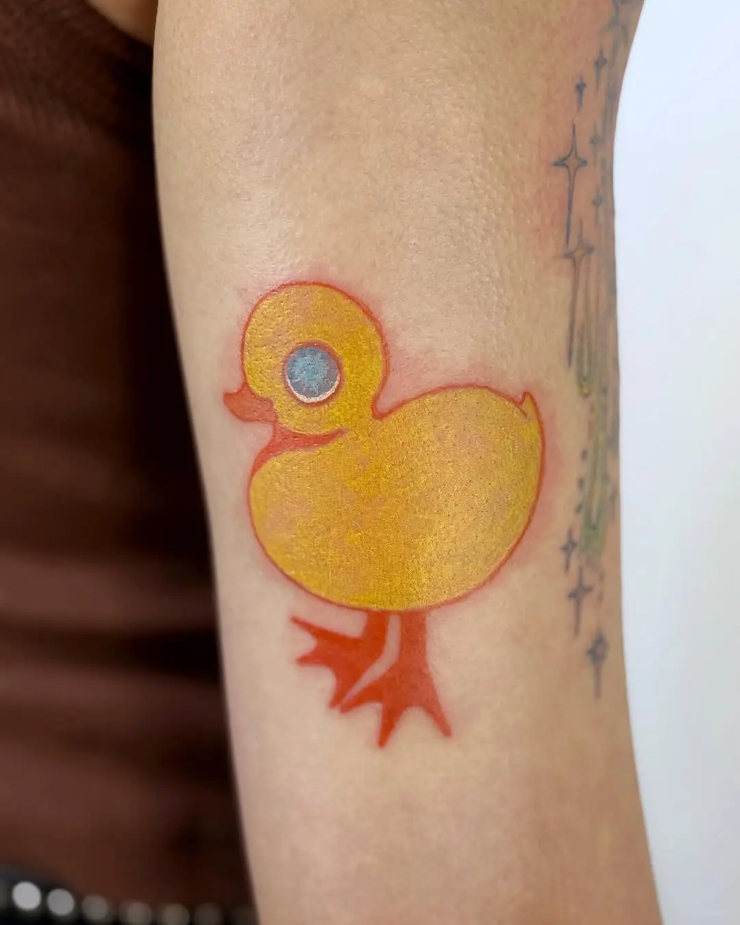 Bright and playful yellow duck tattoo design