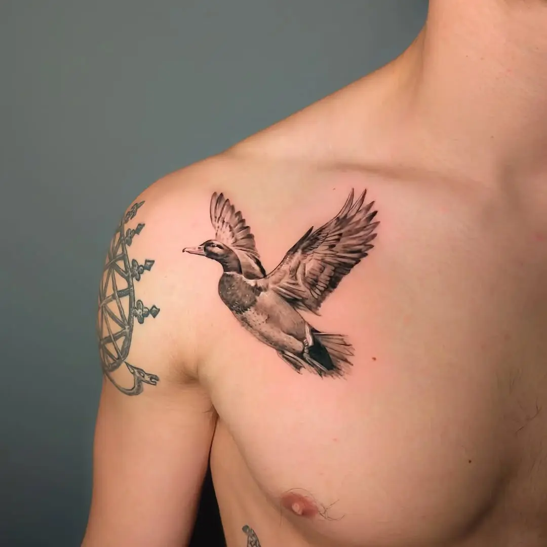 Realistic flying duck tattoo on chest