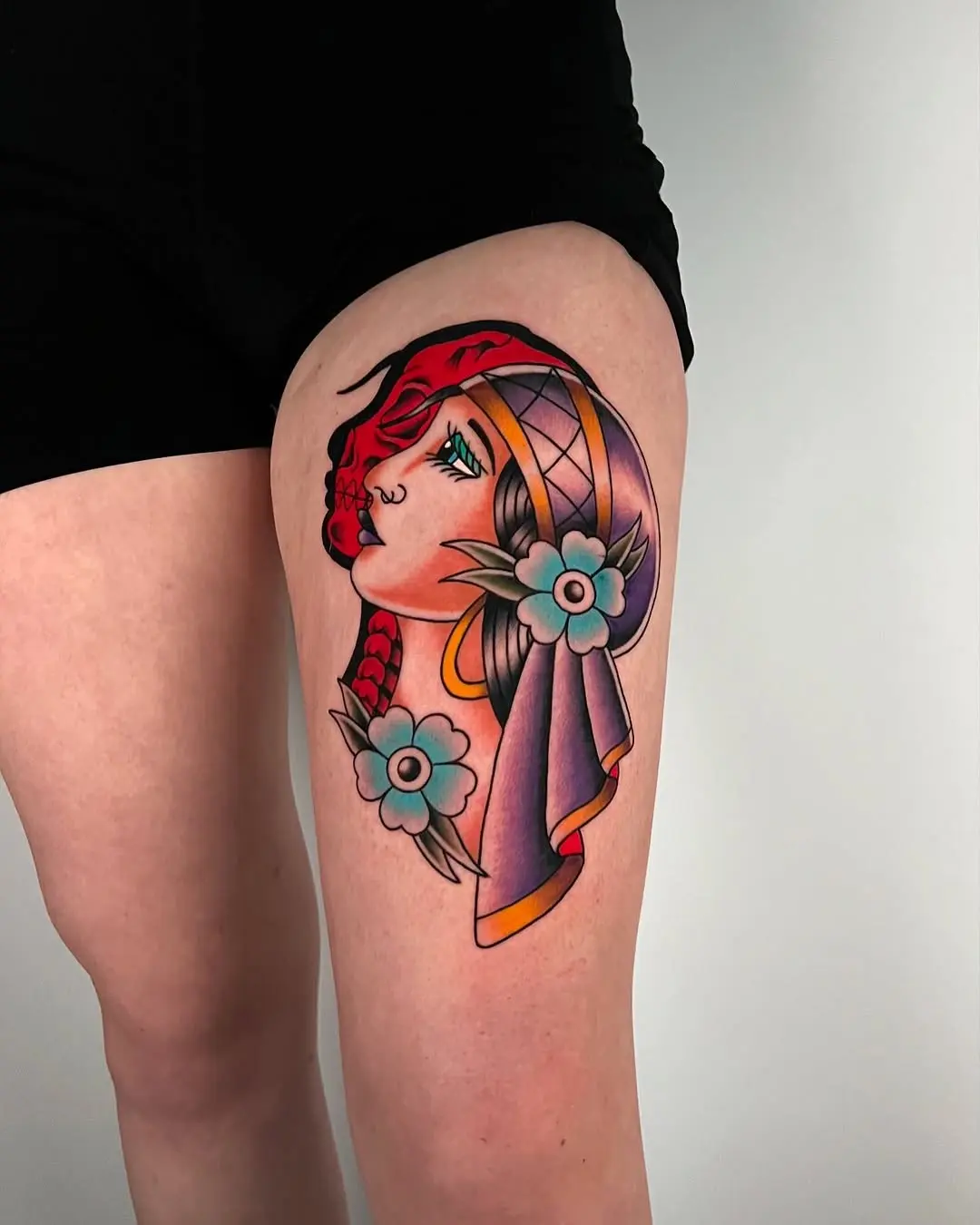 Vibrant Gypsy-Inspired Tattoo with Floral Elements