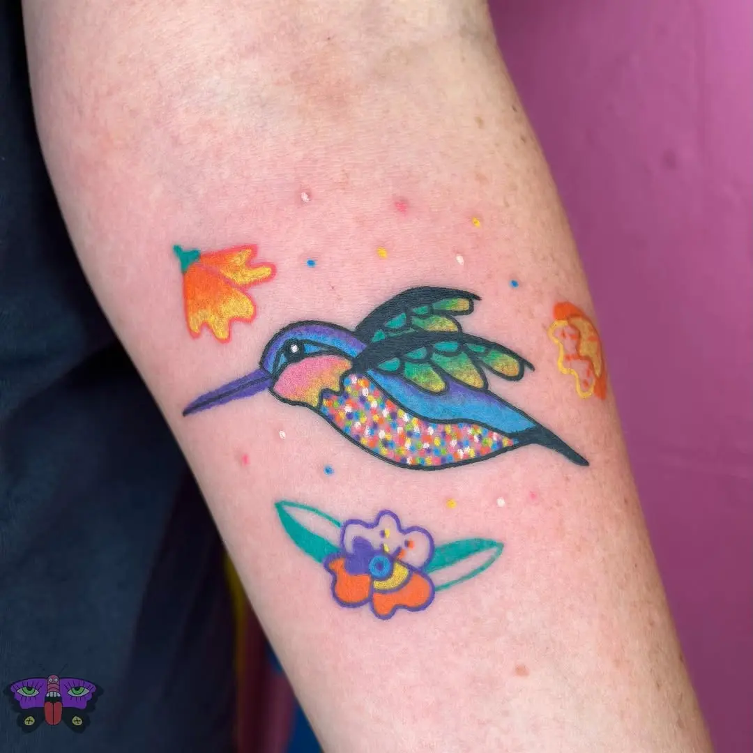 Vivid hummingbird with floral accents tattoo design
