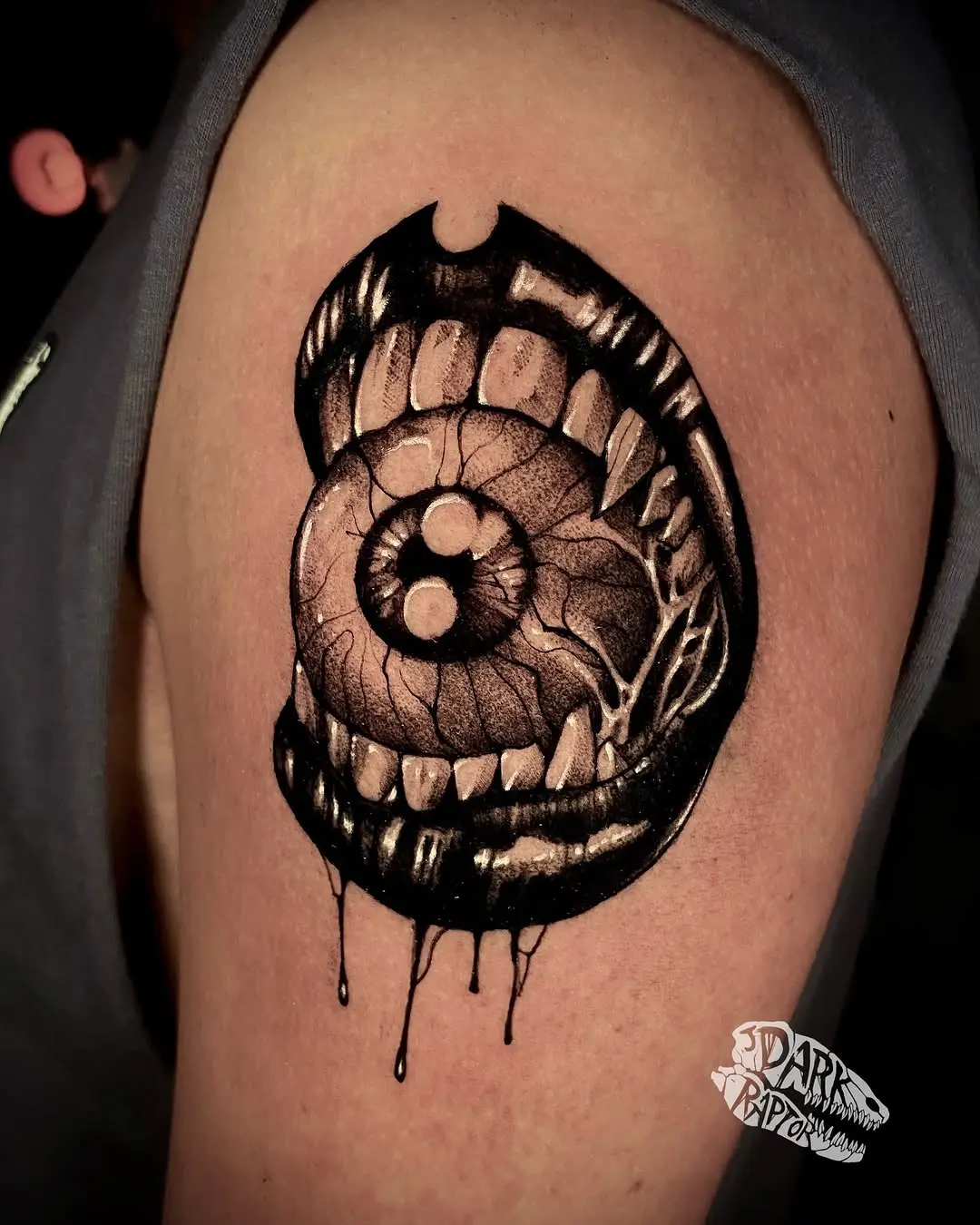 Striking eye within a mouth tattoo design
