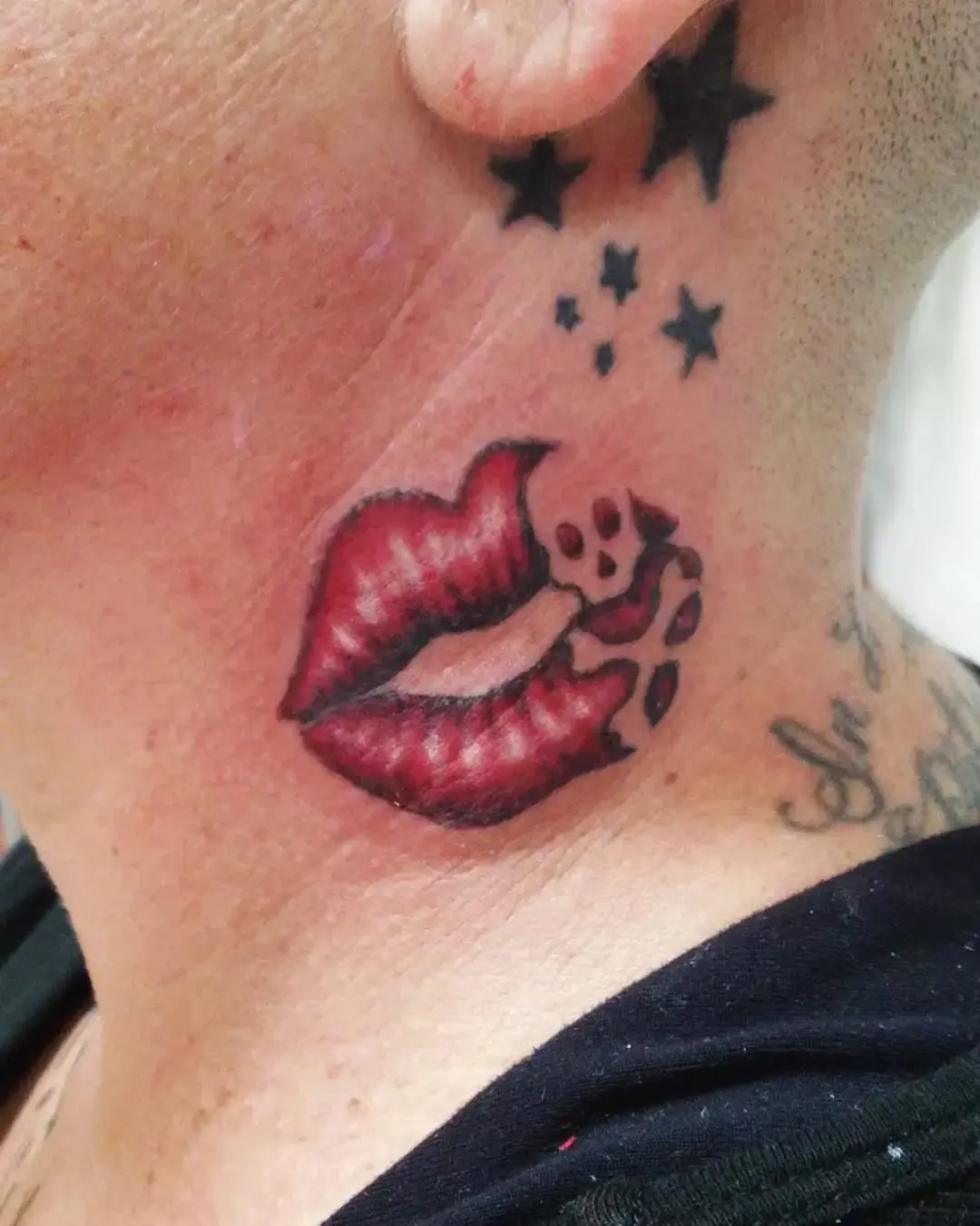 Bold lip tattoo with star accents