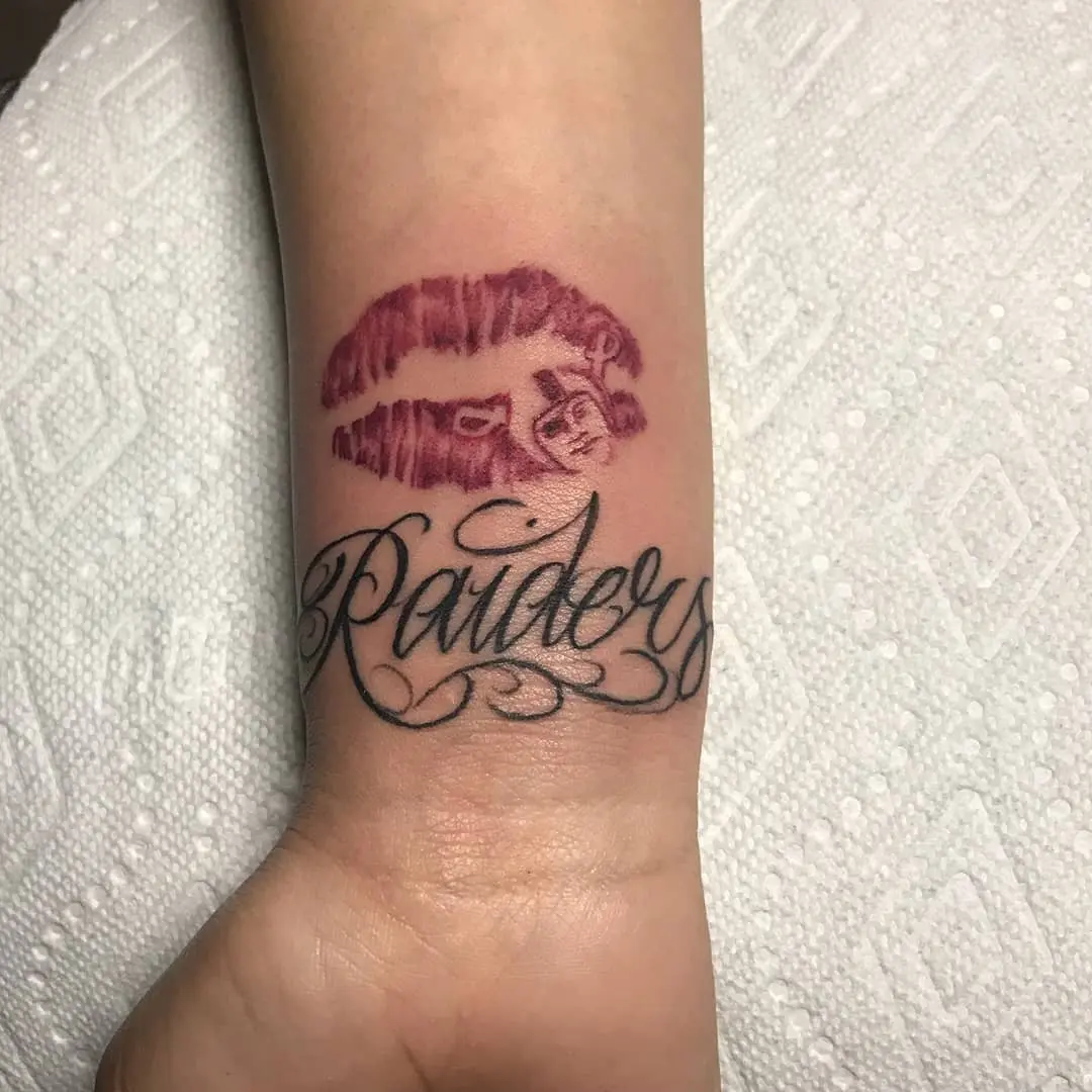 Stylish Lips and Raiders Tattoo Combination