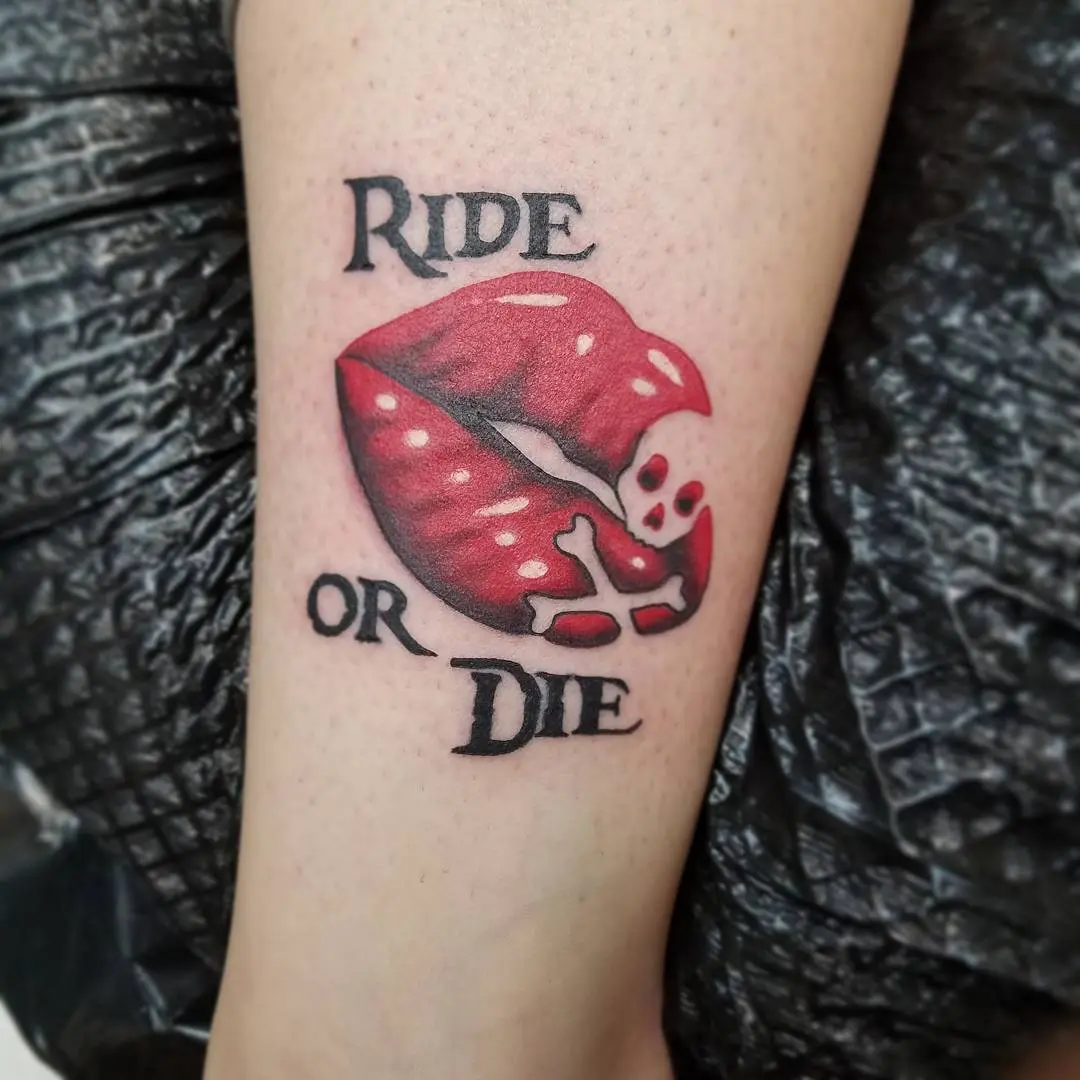 Bold lips tattoo with a fierce mantra