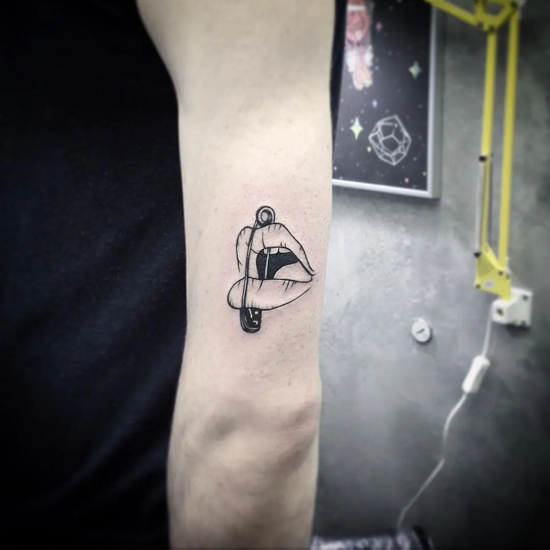 Bold Lips Tattoo with Intriguing Safety Pin