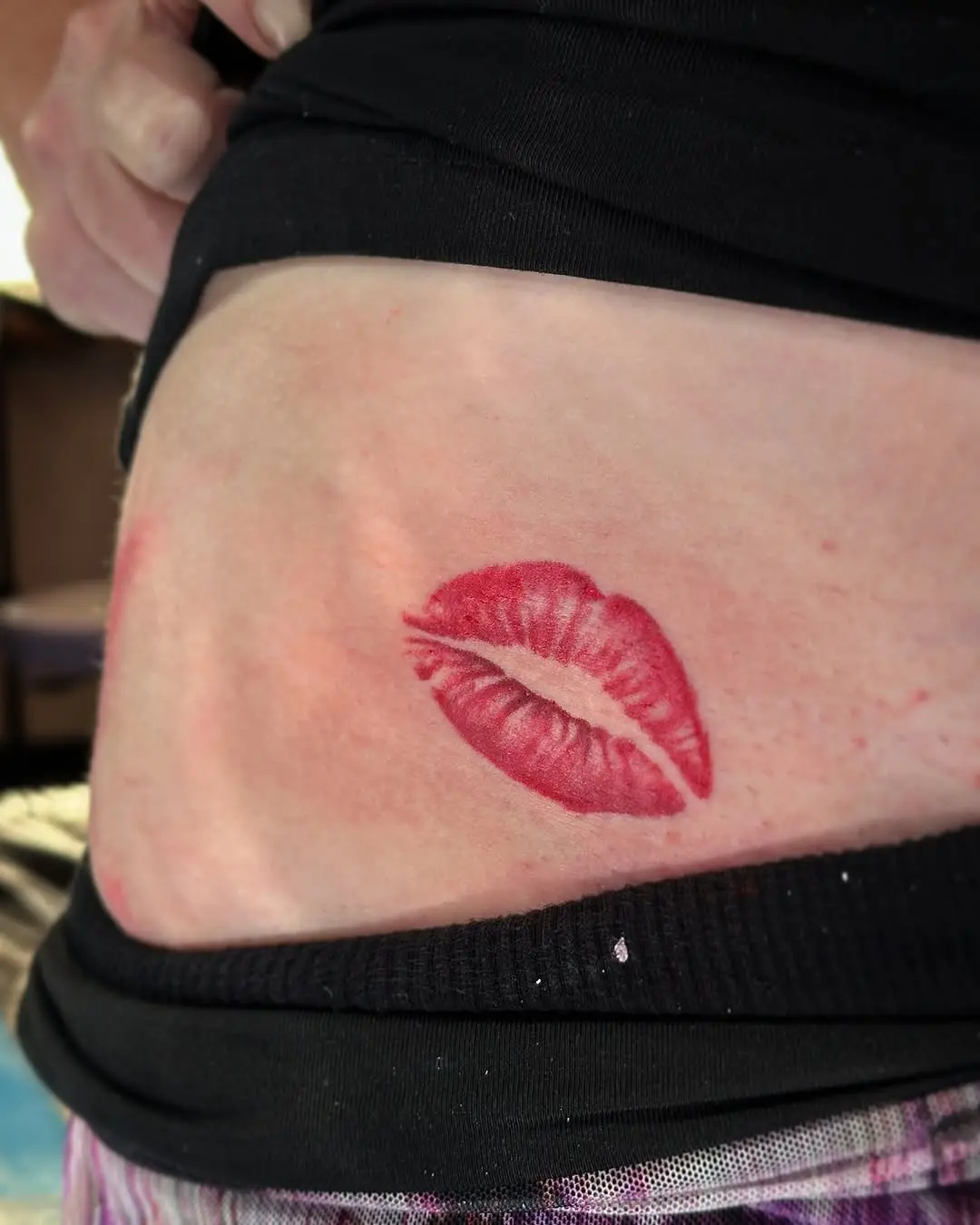 Seductive lip tattoo adds playful vibe