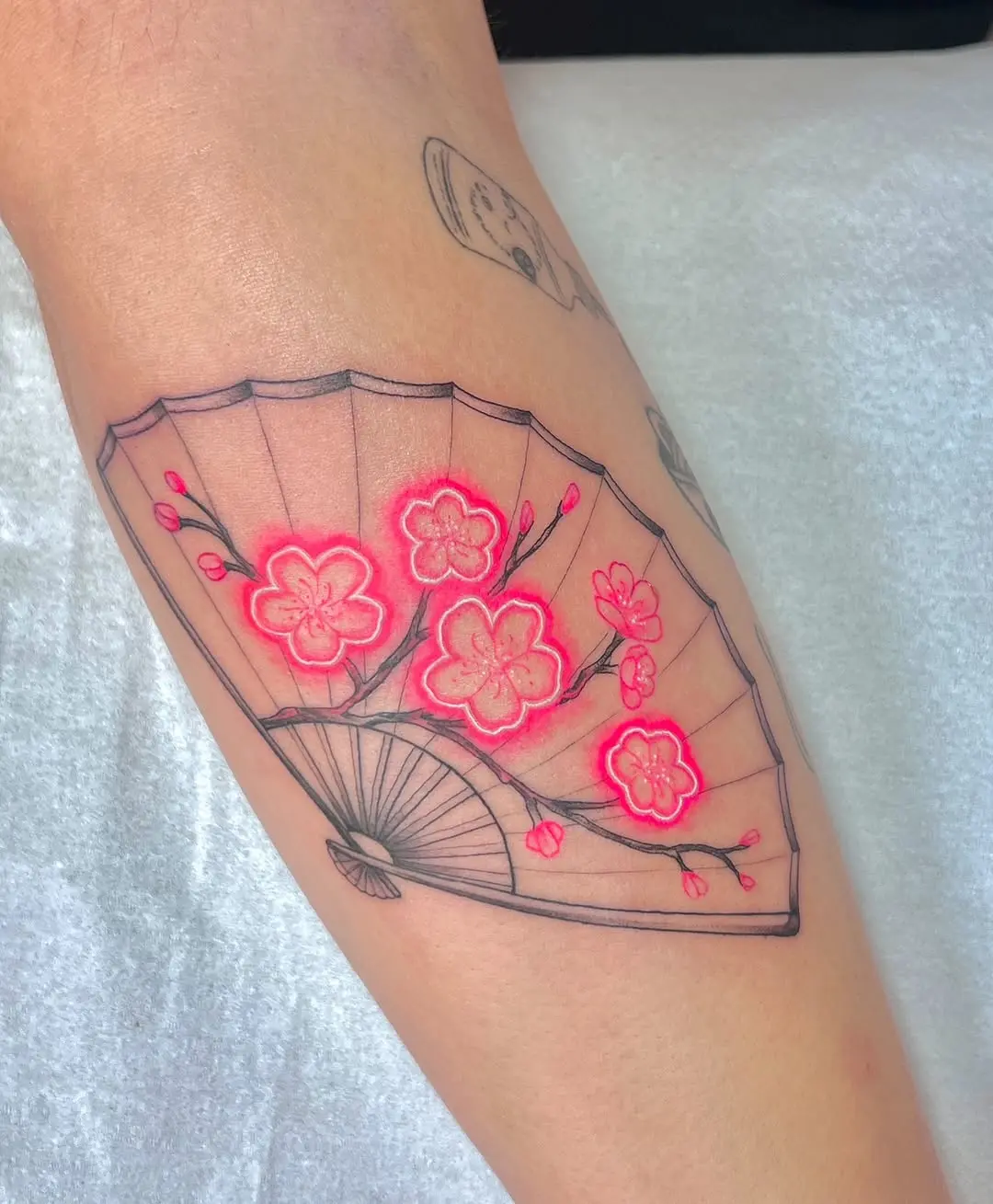 Radiant cherry blossom fan tattoo design