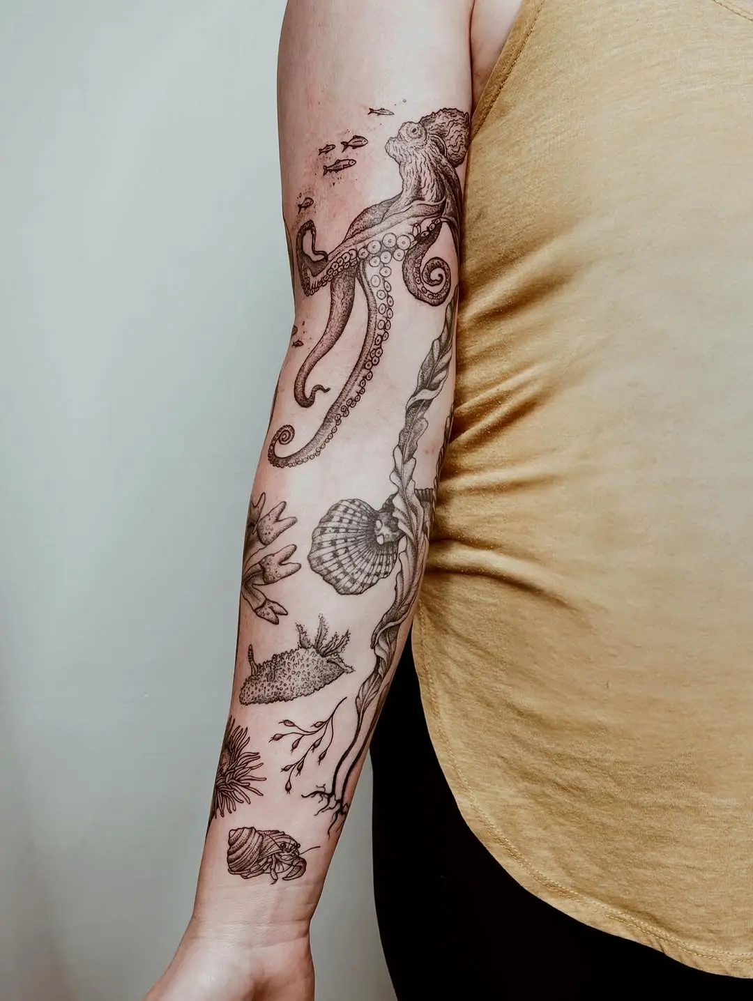 Intricate underwater-themed arm tattoo design