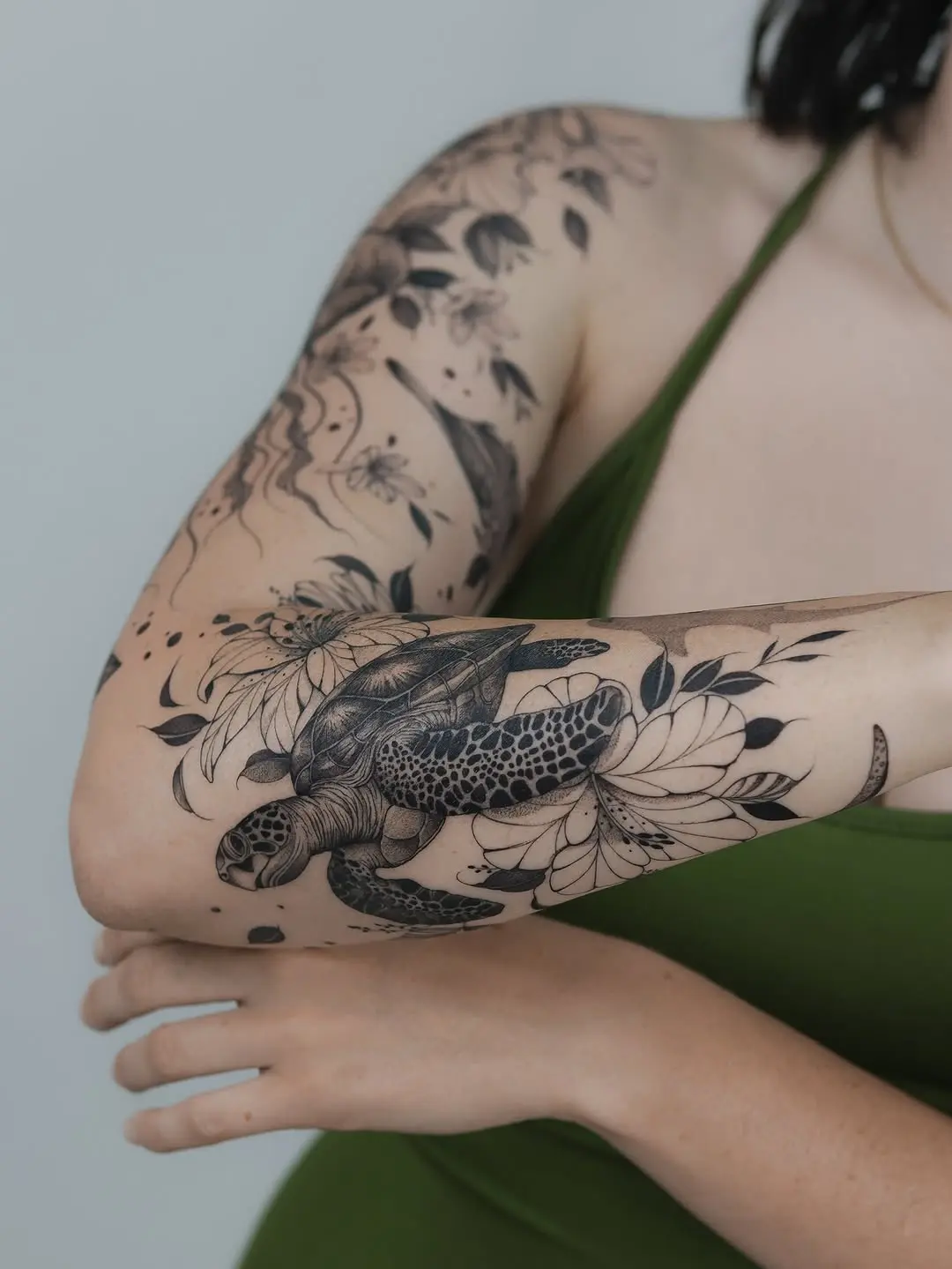 Elegant sea turtle tattoo with floral elements