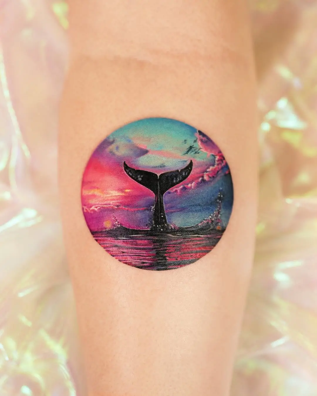 Vibrant Whale Tail Tattoo Against a Dreamy Sky