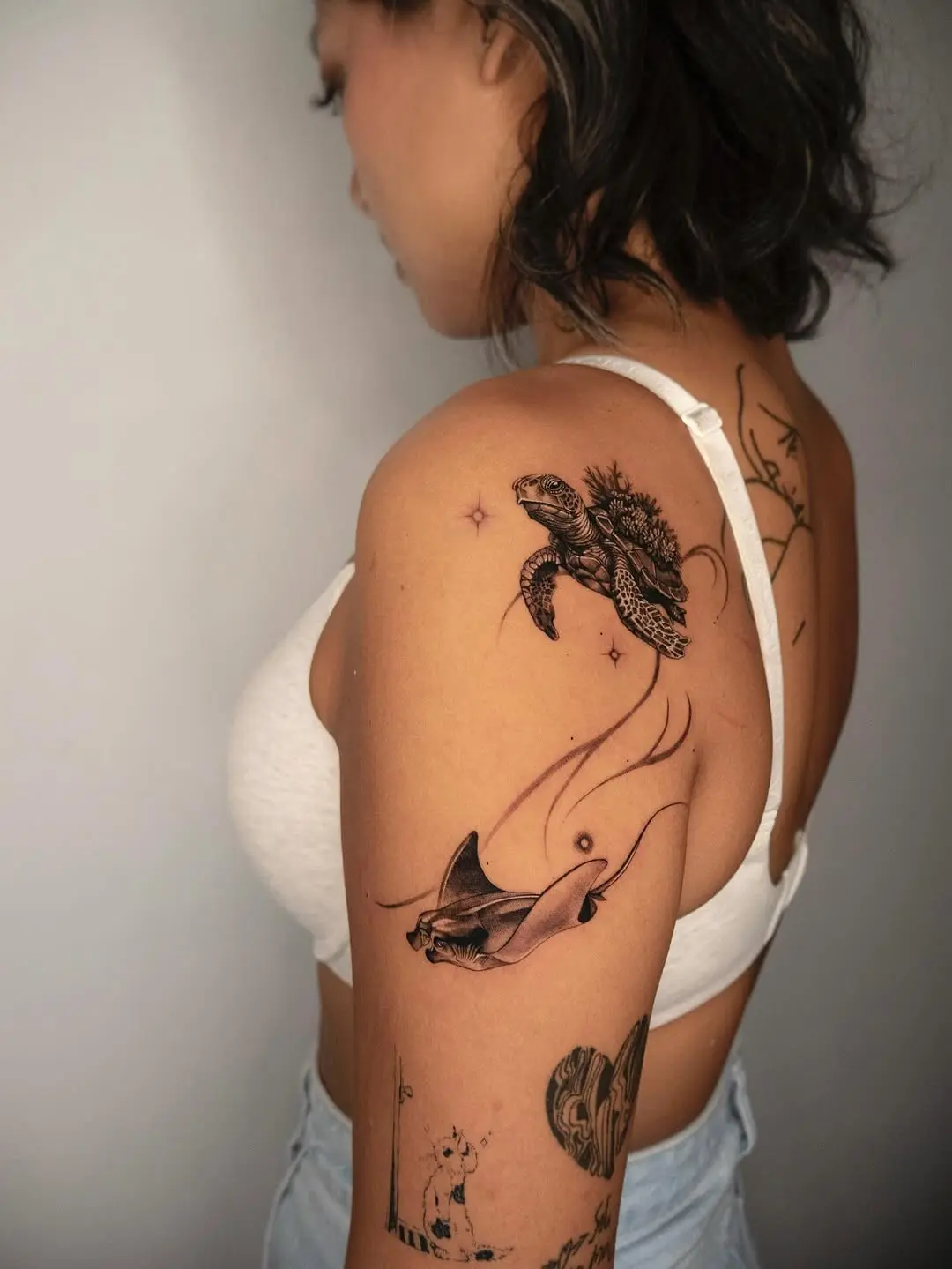 Intricate ocean life tattoos on the arm