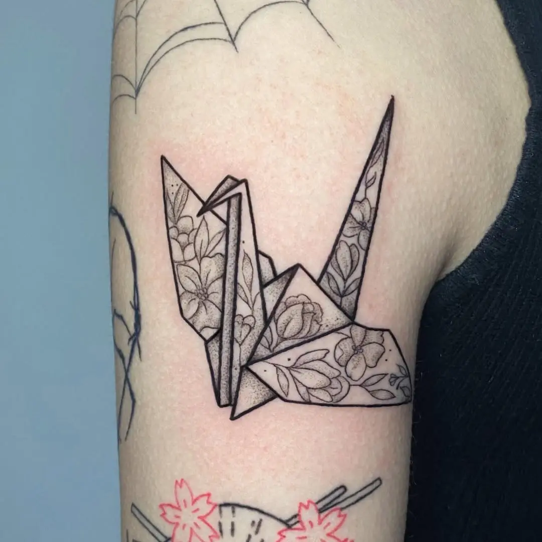 Elegant floral origami crane tattoo concept