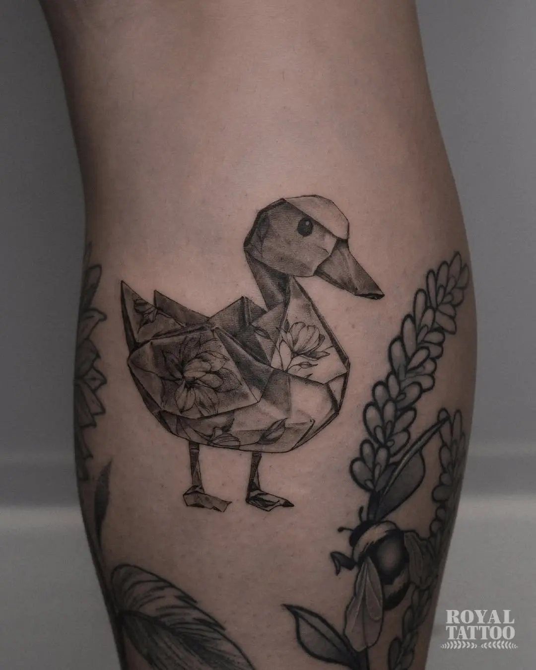 Whimsical origami duck tattoo design in black ink