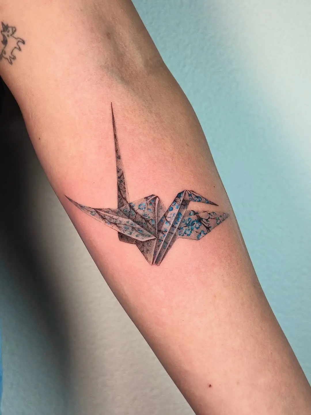 Beautiful origami crane tattoo with watercolor hues