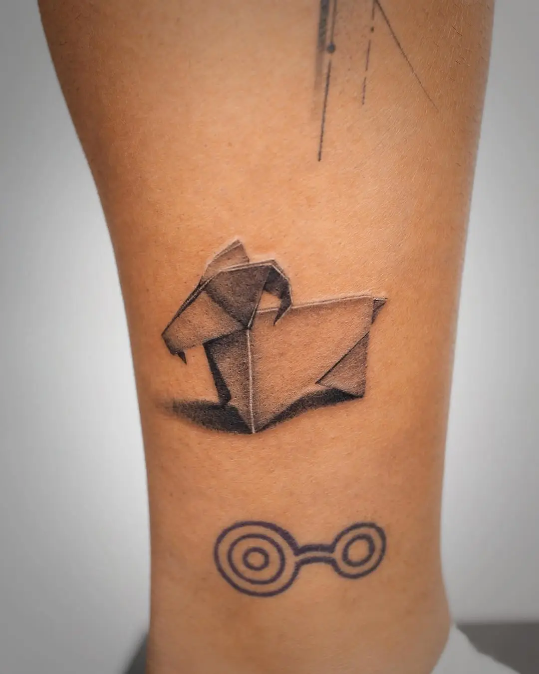 Elegant origami dog tattoo on the calf