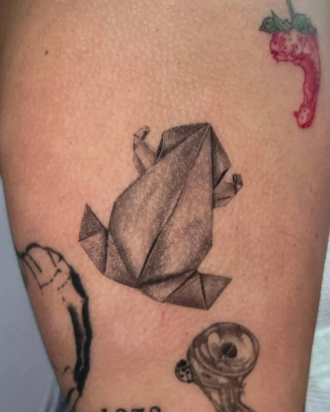 Stylish origami frog tattoo design on skin