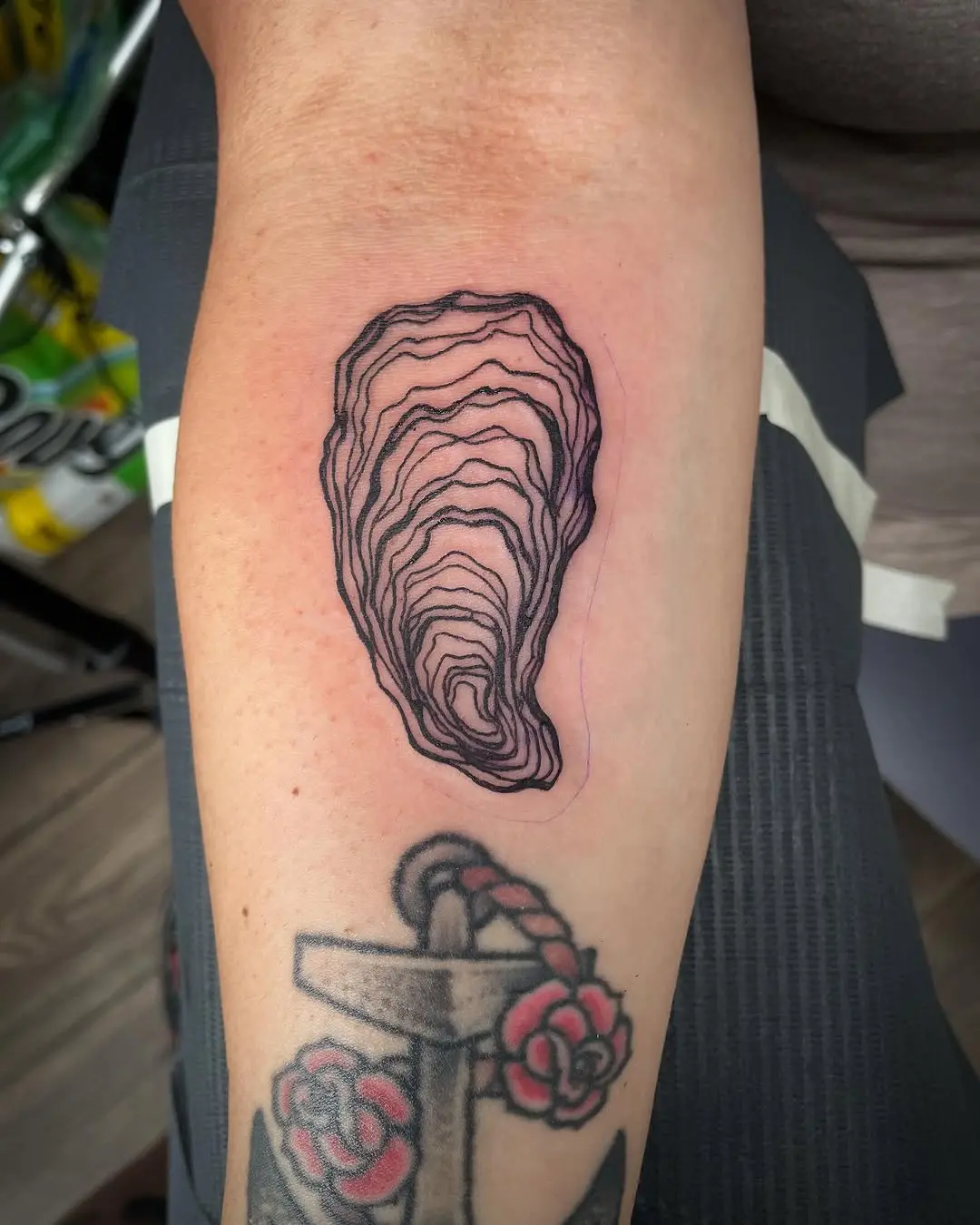 Elegant oyster tattoo with delicate linework