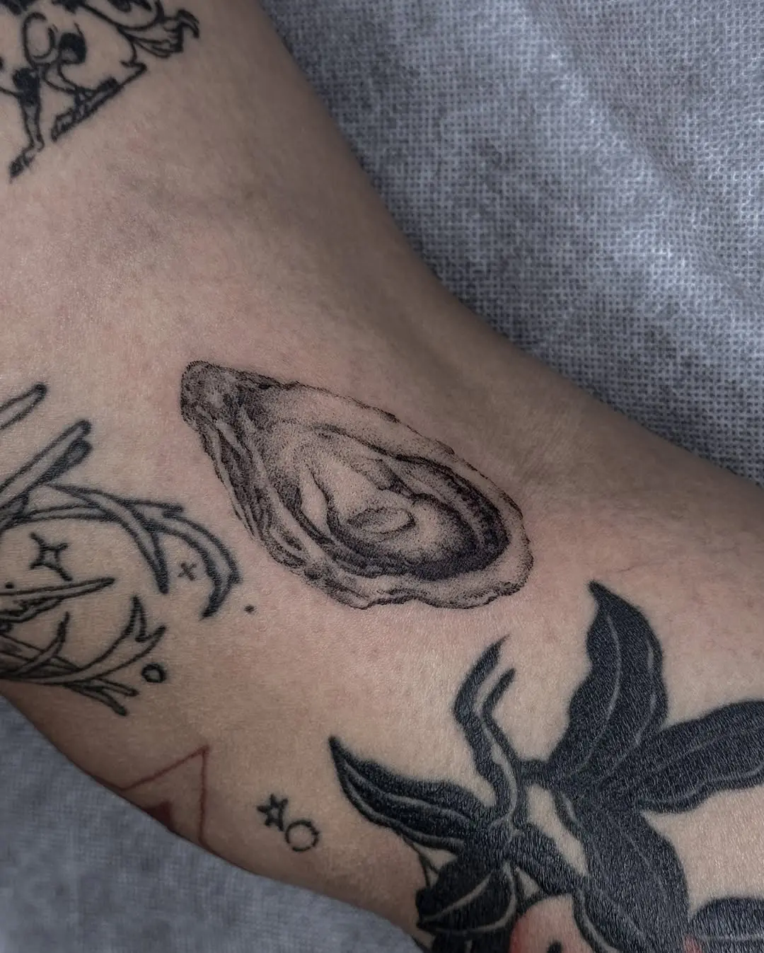 Intricate oyster tattoo with realistic detailing