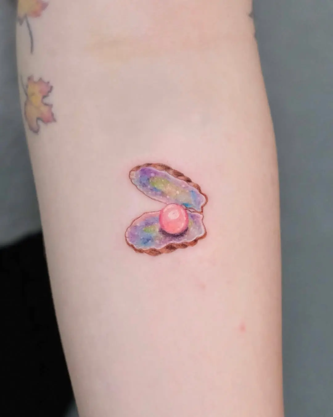 Stunning oyster tattoo with colorful pearl