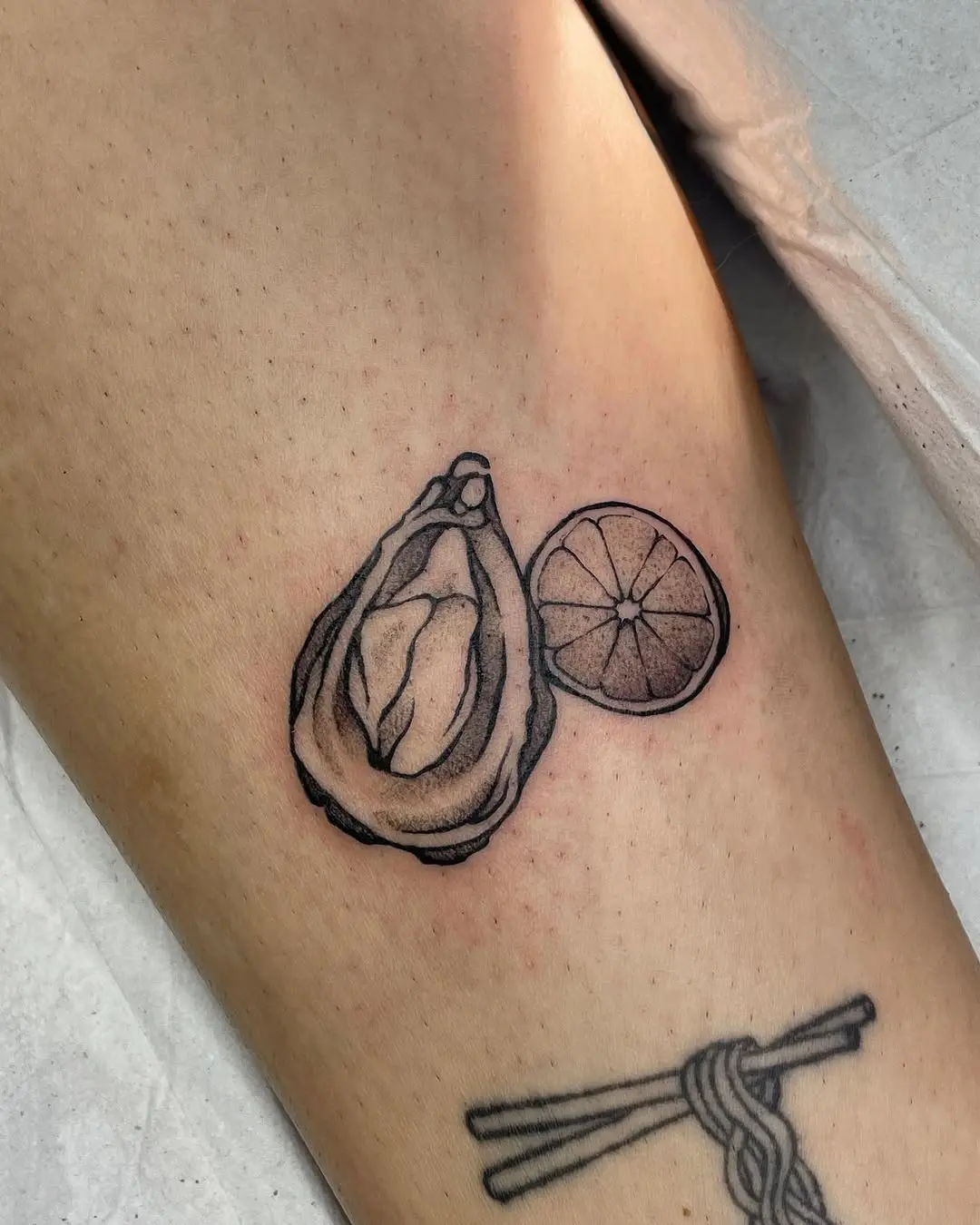 Stylish oyster and lemon tattoo design