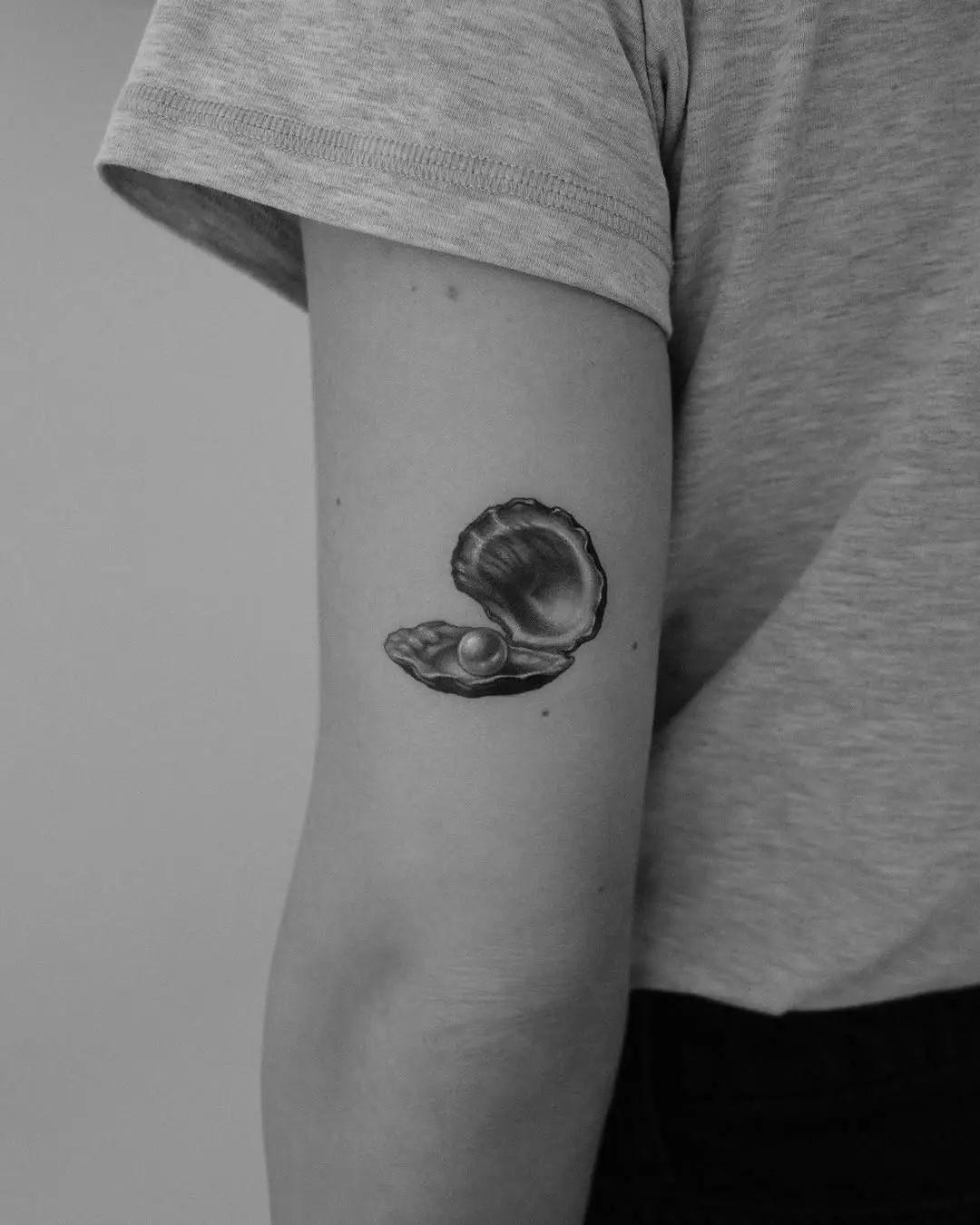 Stunning oyster tattoo with hidden pearl
