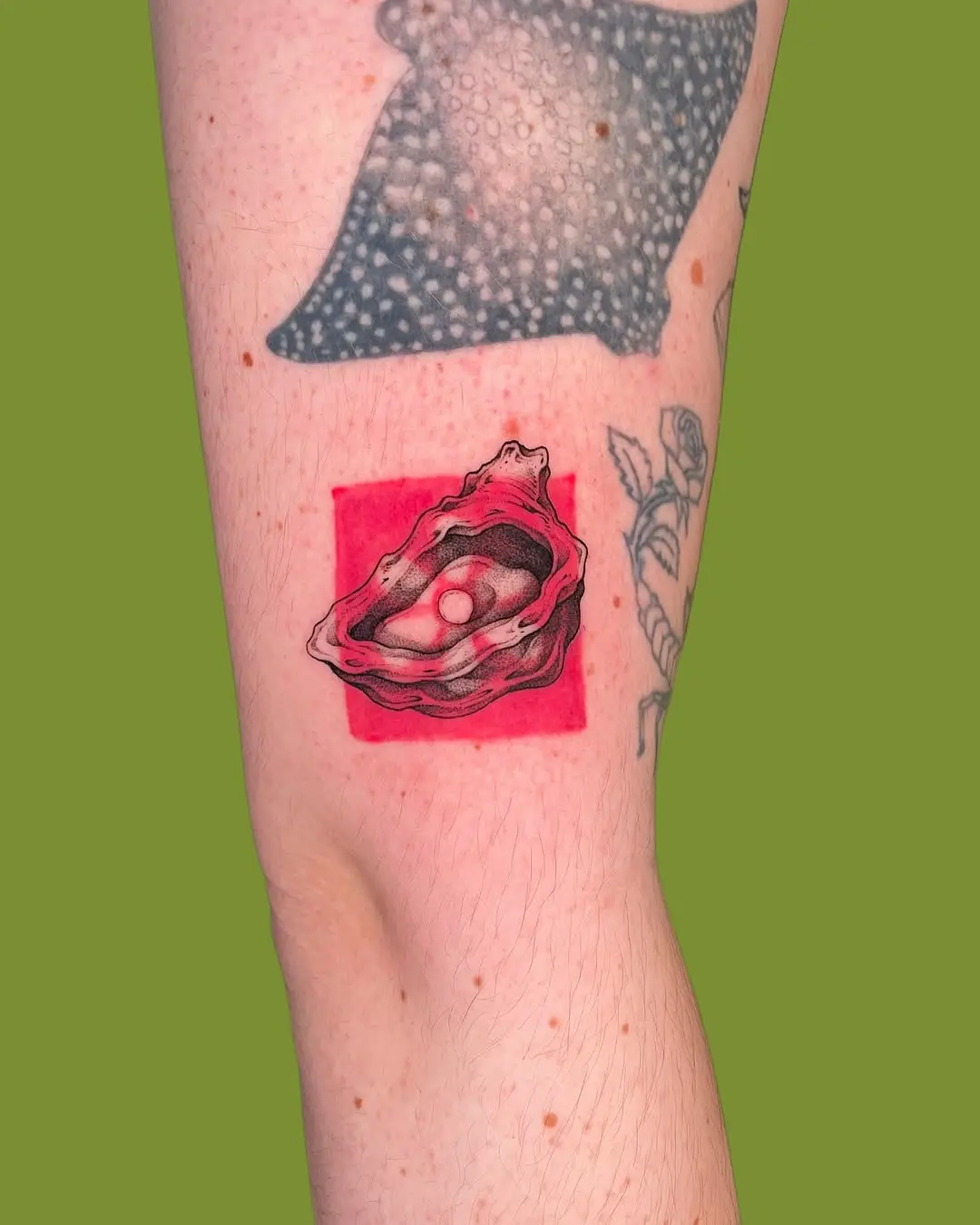 Stunning oyster tattoo with vibrant red detail