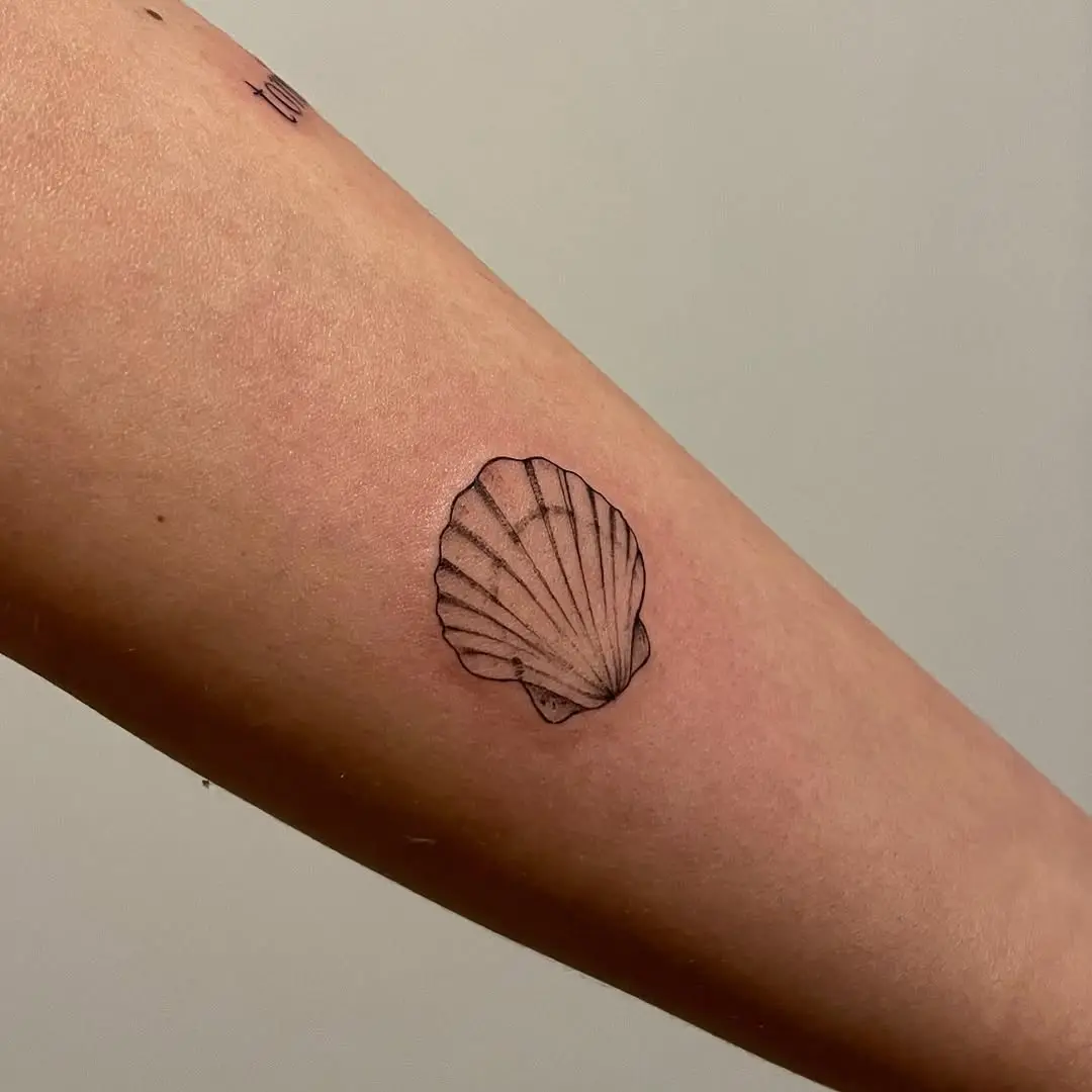 Elegant minimalist oyster shell tattoo design