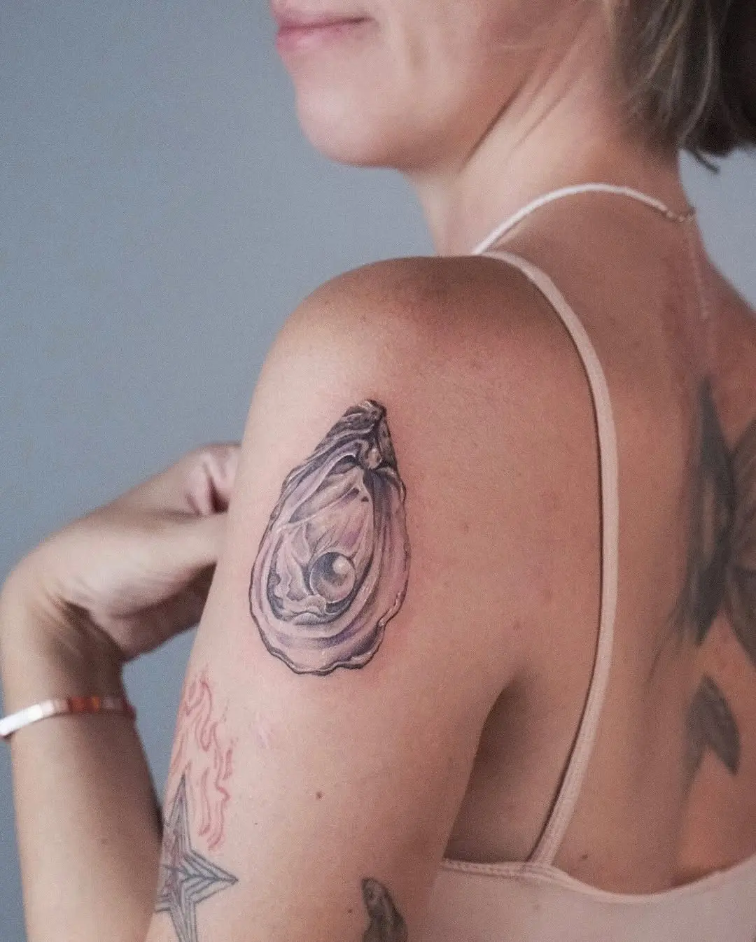 Elegant oyster tattoo featuring a hidden pearl