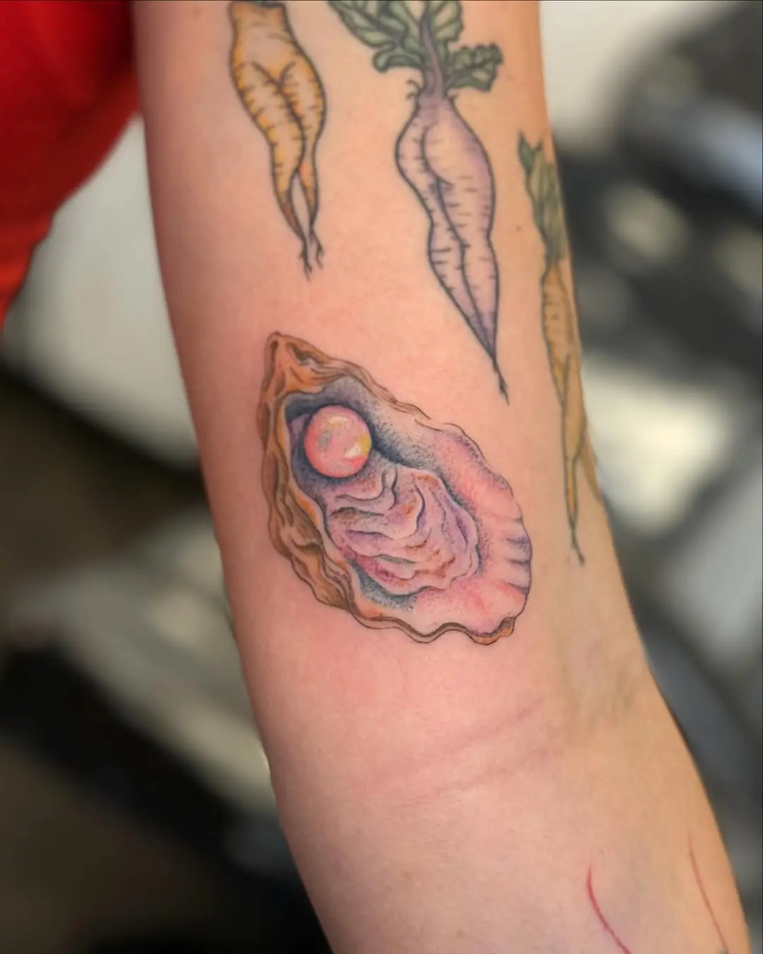 Vibrant oyster tattoo with a pearl focus