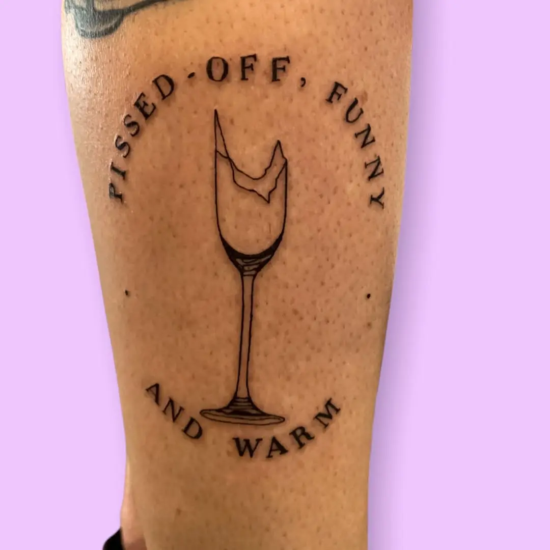 Charming champagne glass tattoo with a twist