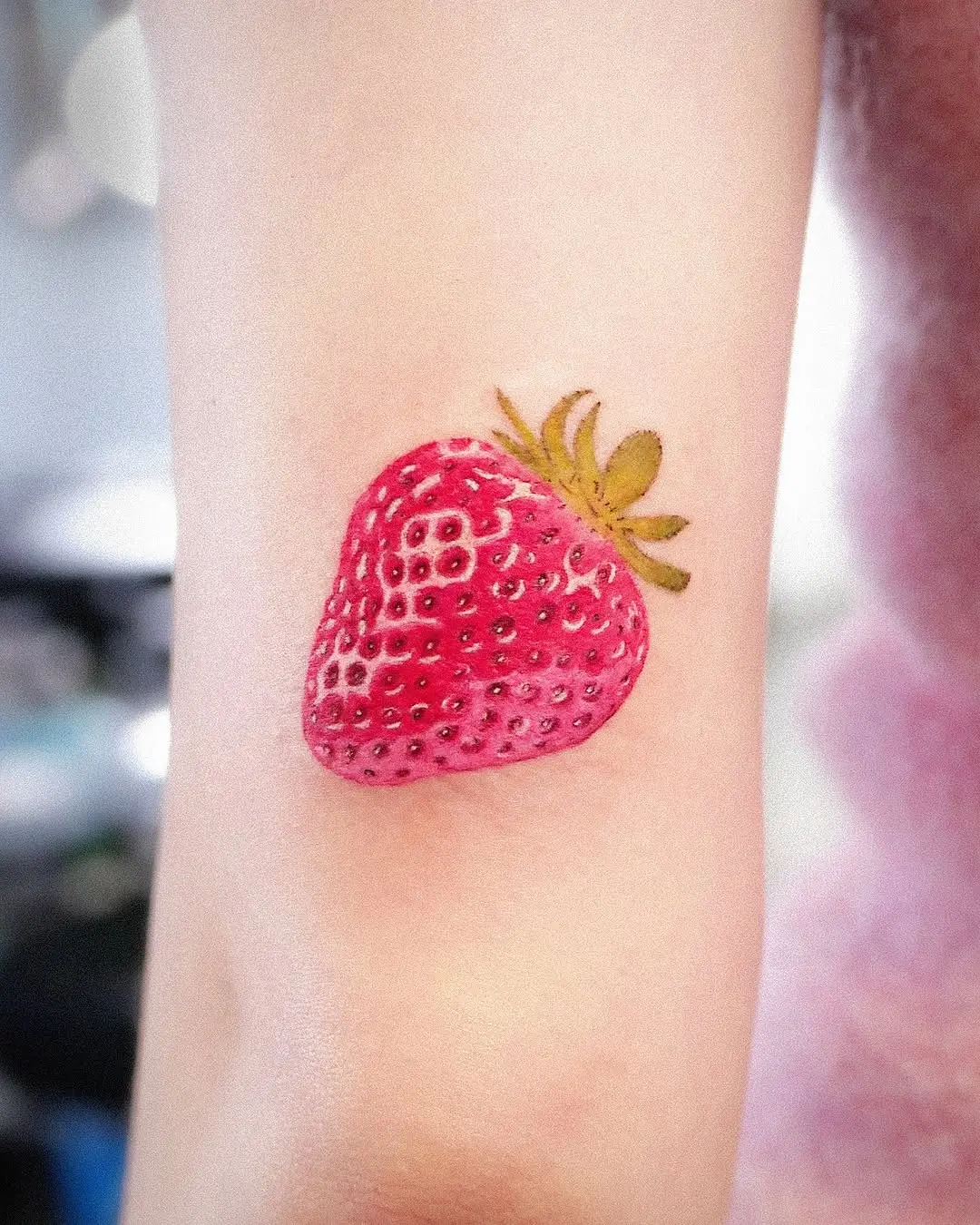 Vibrant Strawberry Tattoo on Display