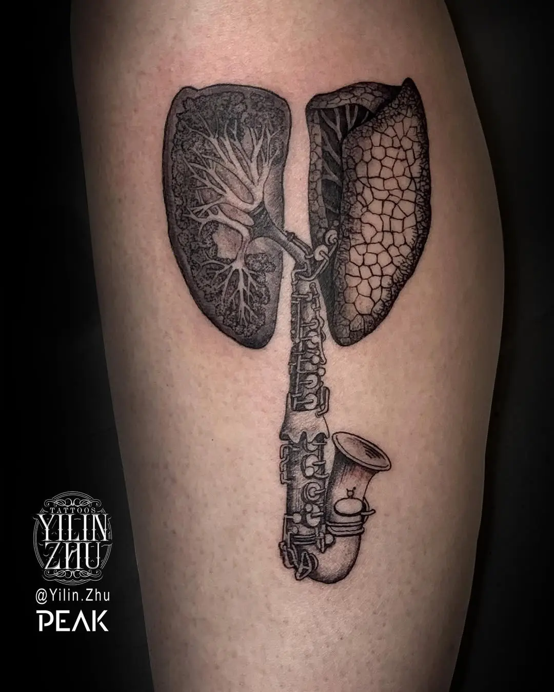 Unique lungs and saxophone tattoo design
