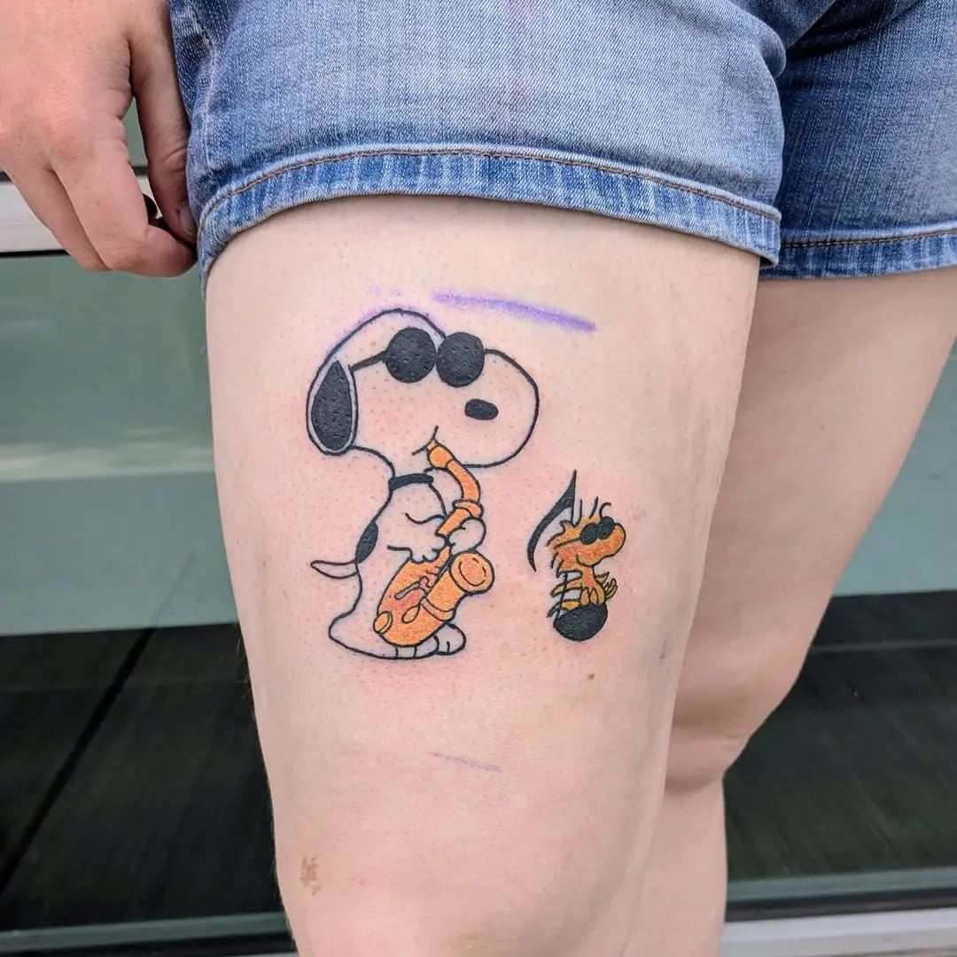 Whimsical saxophone-playing Snoopy tattoo design