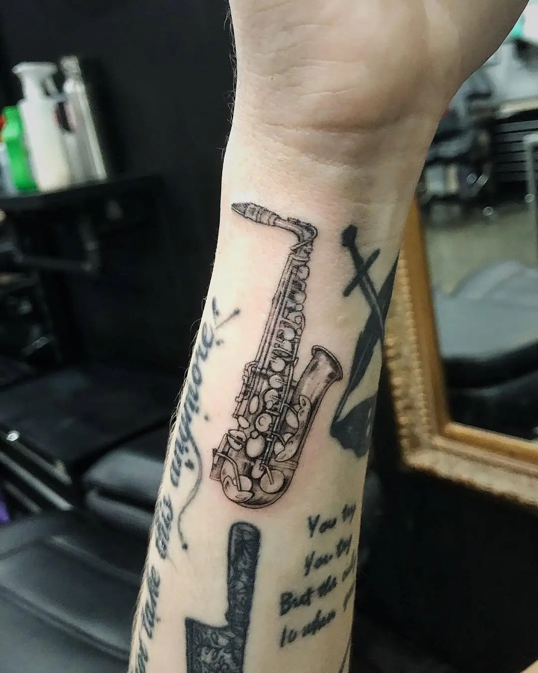 Stylish saxophone tattoo on the forearm