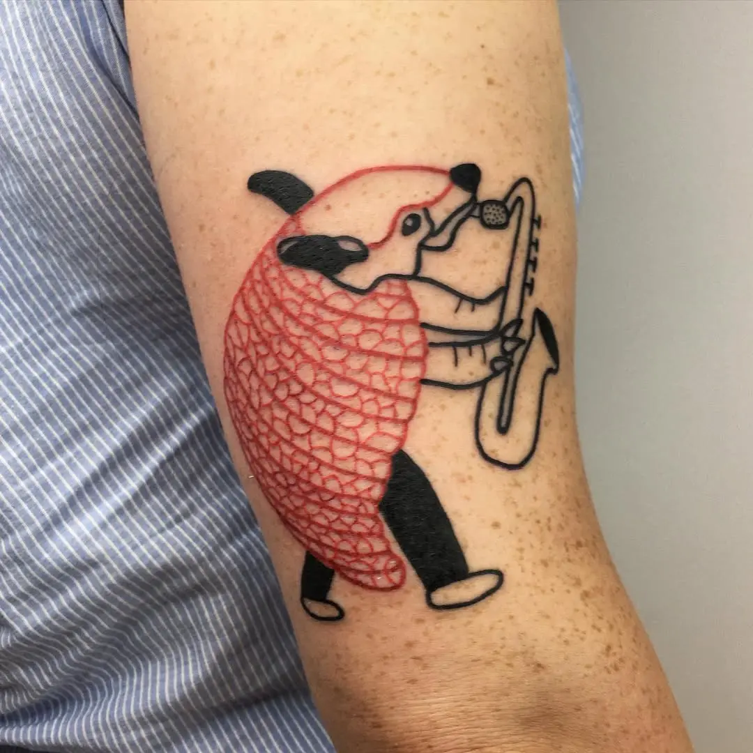 Unique saxophone tattoo featuring playful animal art