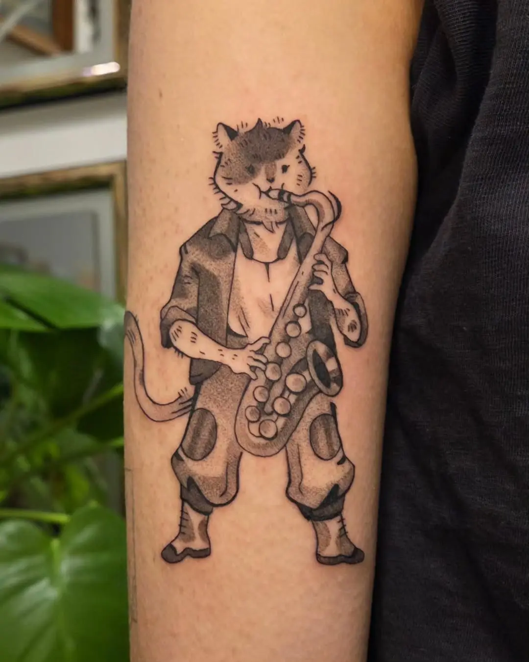 Whimsical cat playing saxophone tattoo art