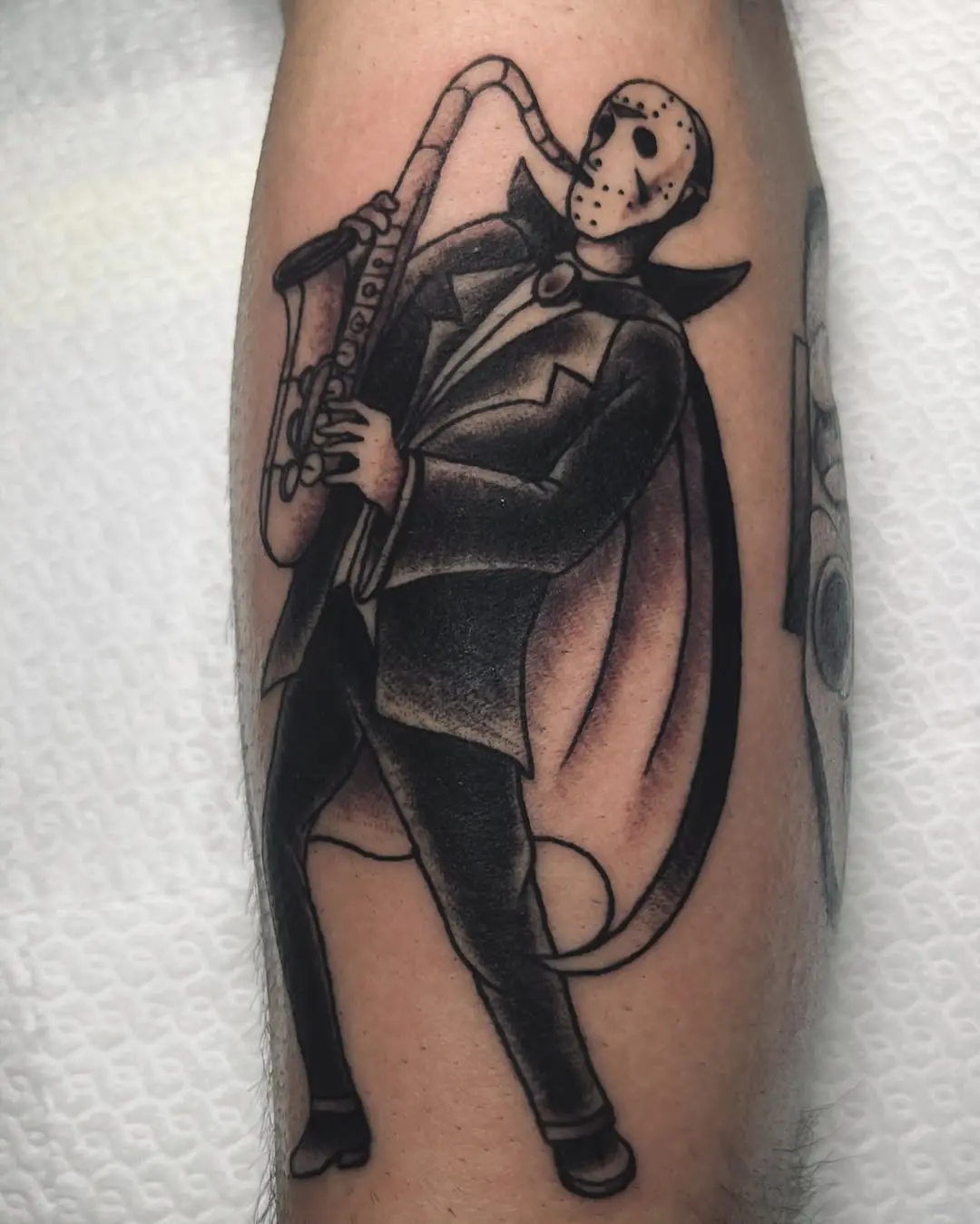 Unique saxophone tattoo featuring a horror twist