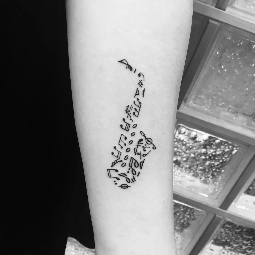 Elegant saxophone tattoo with musical notes inspiration