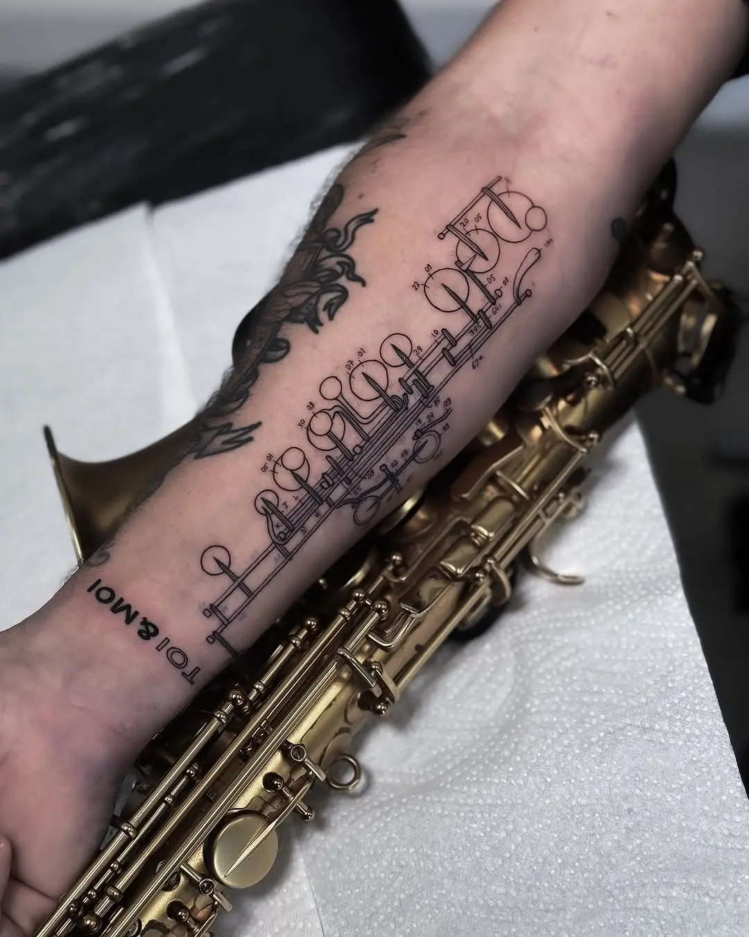 Elegant tattoo blending music with artistry
