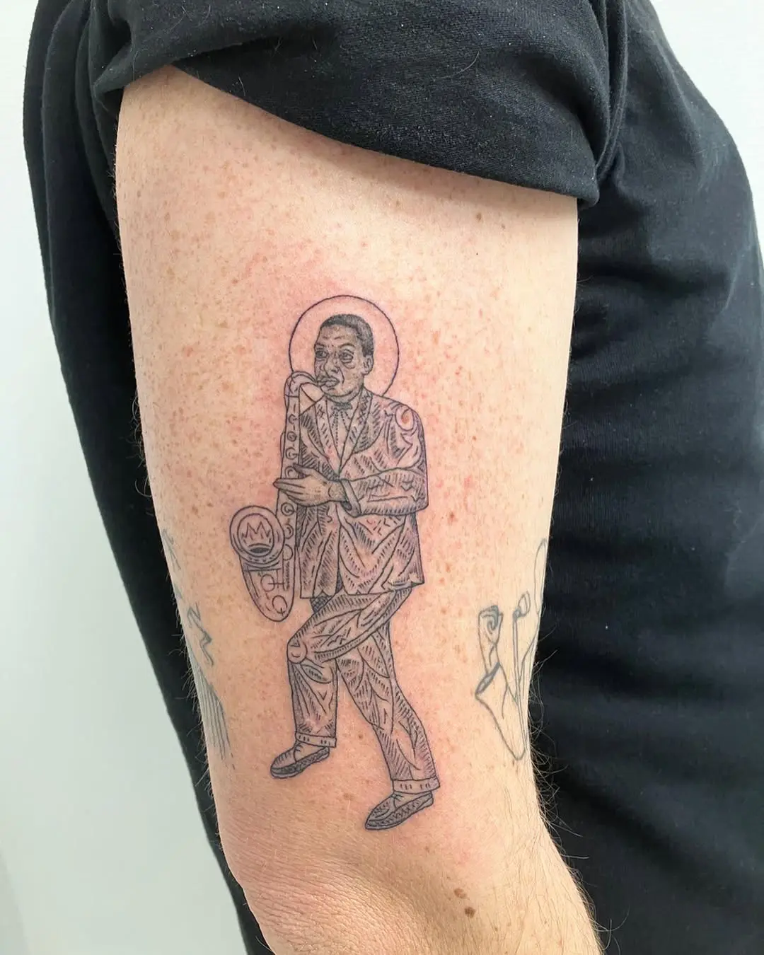 Stylish saxophone tattoo celebrating musical legacy