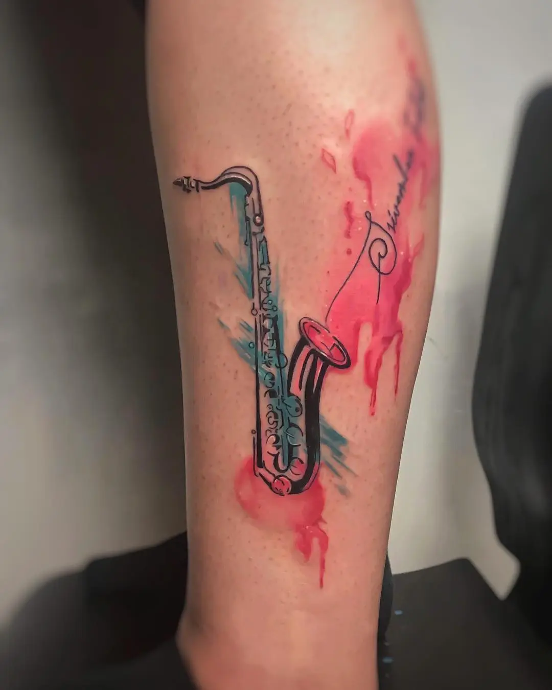 Vibrant saxophone tattoo with splashy colors