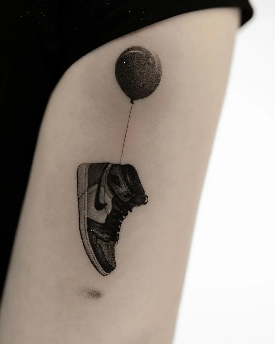 Creative shoe tattoo with a playful balloon