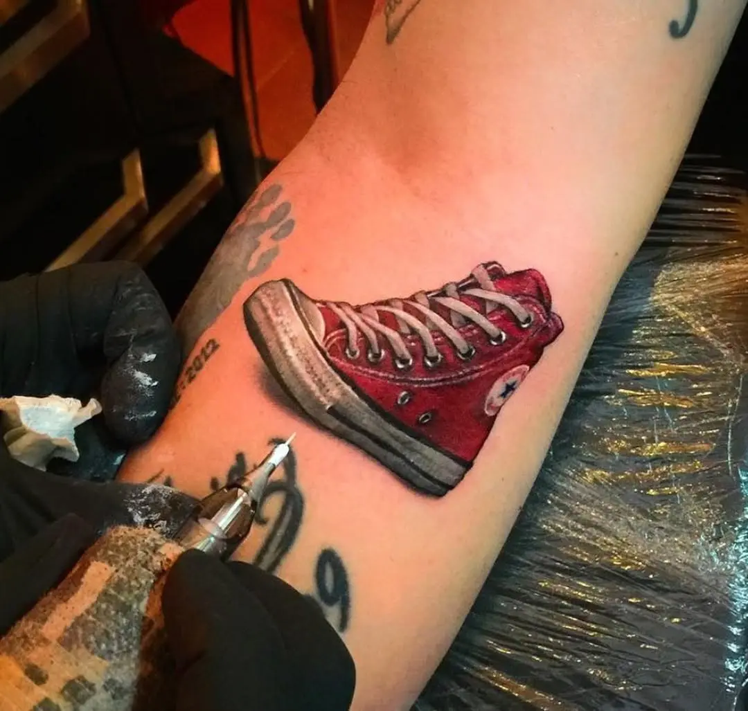Stylish red Chucks tattoo design on arm